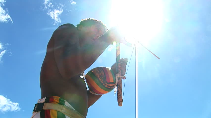 SALVADOR, BRAZIL - April 2008: Bright sun and man playing Berimbau in Salvador, Brazil