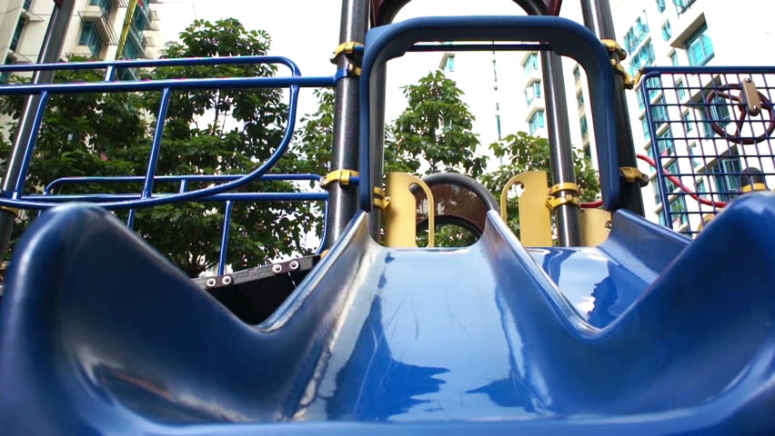 Pembroke Welsh Corgi sliding down a slide.
