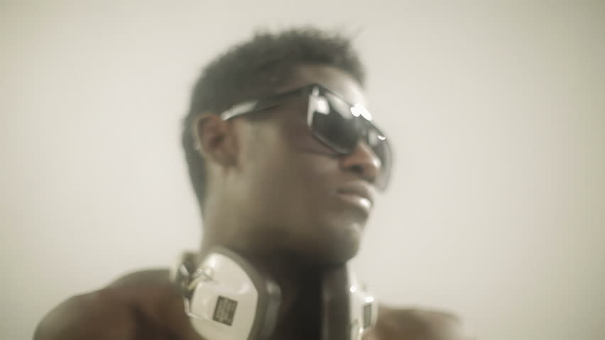 young african guy waving and dancing with a cool attitude with glasses