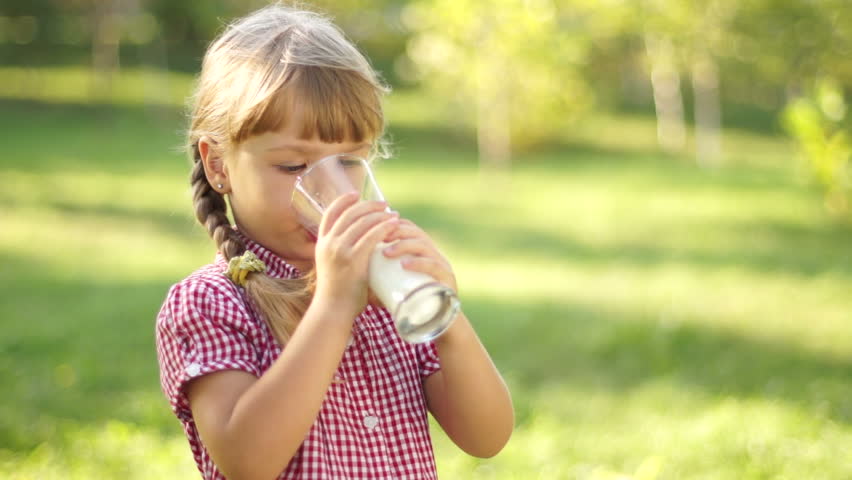 Portrait of smiling girl drinking milk. Milk mustache. Thumbs up. Ok.
