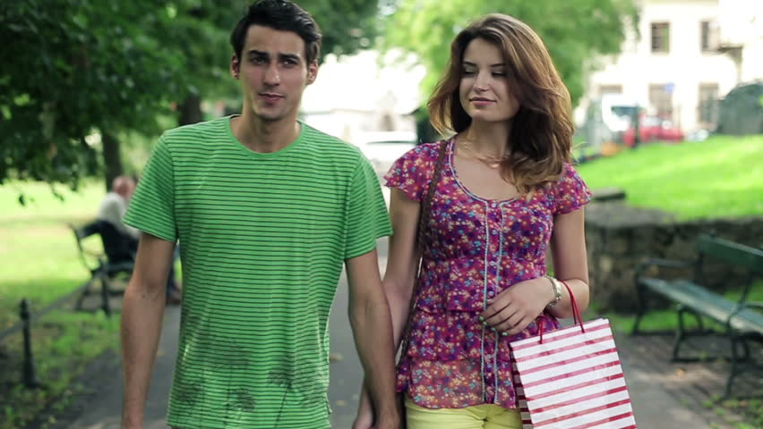 Happy couple in love walking in the park
