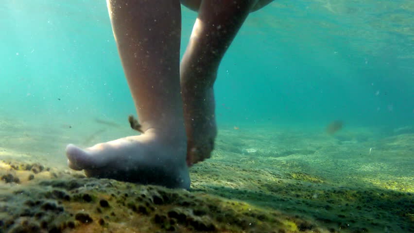 Child walking under the water

