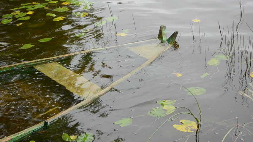 drowned wooden old boat after storm in lake