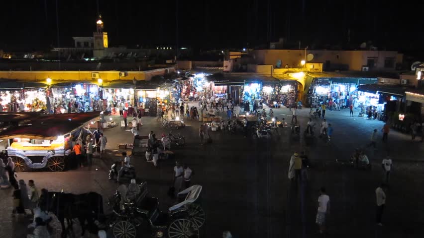 MARRAKECH, MOROCCO - CIRCA 2012: Jemaa el-Fnaa square. The imam, the community leader, makes the call to prayer at night during Ramadan, Marrakech, Morocco.