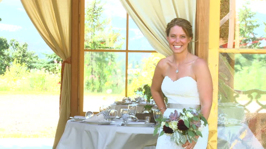 Model released bride waving to camera on her wedding day.
