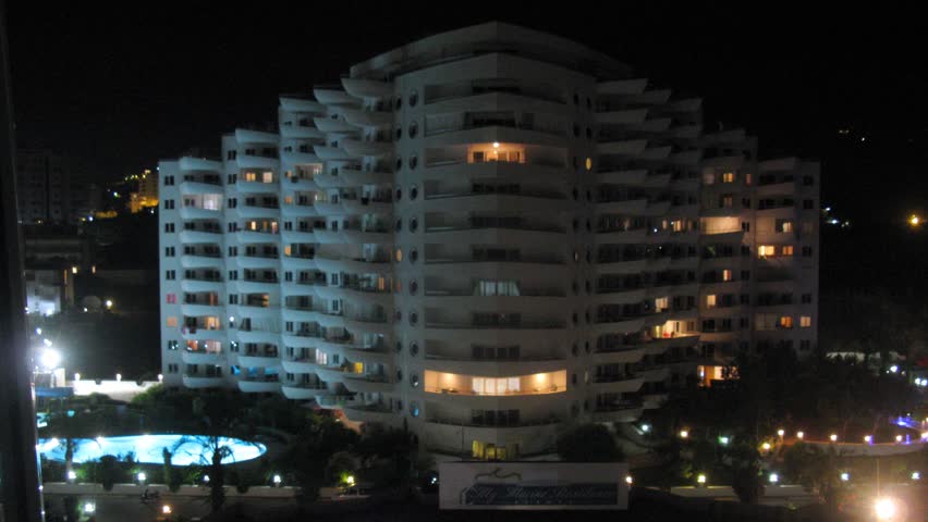ALANYA - JUL 13: (Timelapse View) People swim in pool near housing estate My Marine Residence at night, on Jul 13, 2012 in Alanya, Turkey. In Housing estate of My Marine Residence 381 apartments