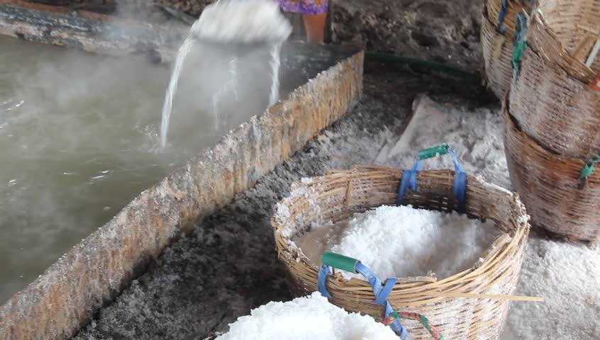 a farmer shoveling salt on a pan
