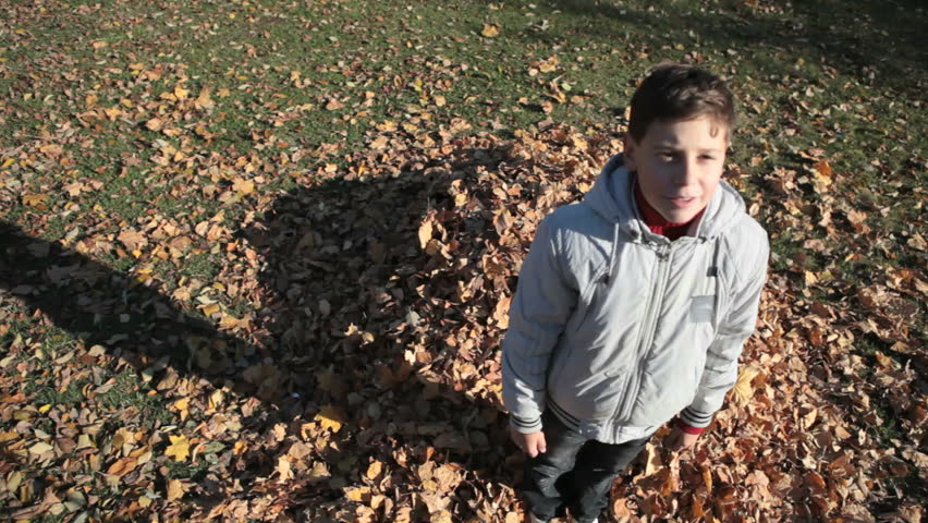 Teen boy falling onto the hip of leaves and messing all up