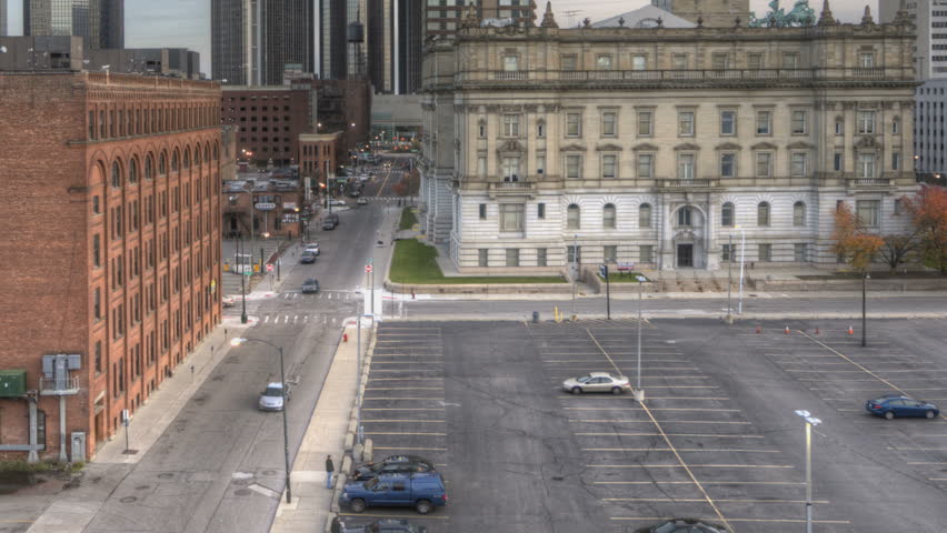 DETROIT, USA, NOV 7, 2011: HDR Timelapse Skyline downtown Detroit sunset from day to night with dark clouds passing by from elevated viewing point and traffic at a crossing