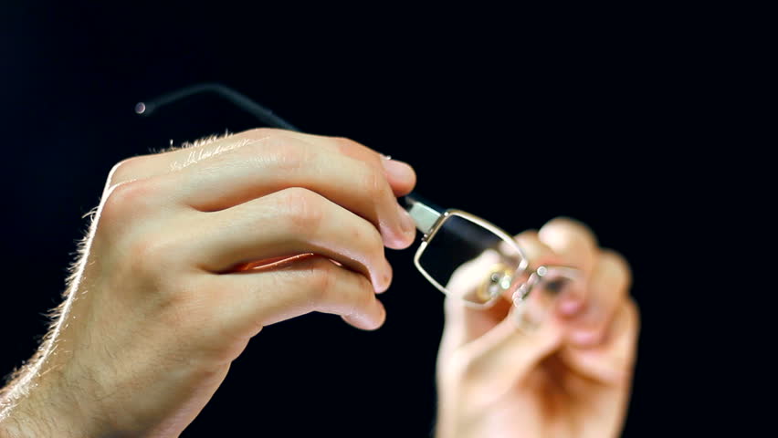A man checking it's eyesight glasses. Very careful not to destroy the glass and framework of glasses, there is already a bit of error on the glasses. HD1080p.