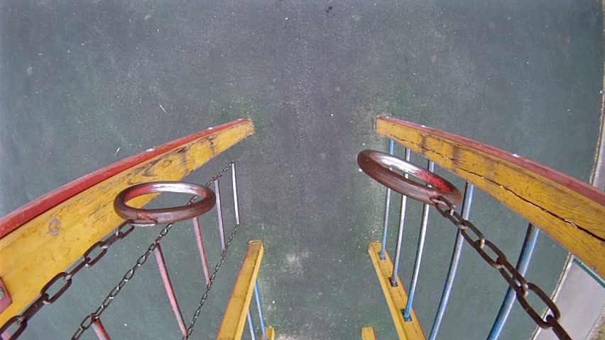 Teenager hang on sports rings at playground in house yard