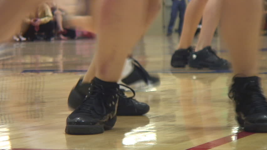 Footwork on the hardwood court at high school women's basketball game.