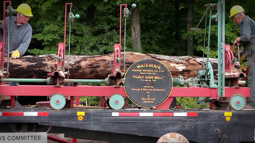 WATERLOO, ONTARIO - SEPTEMBER 21: Men operating an old-fashioned pony saw mill on September 21, 2012 in Waterloo, Ontario. This 150-year-old technology was the primary method of sawing lumber.