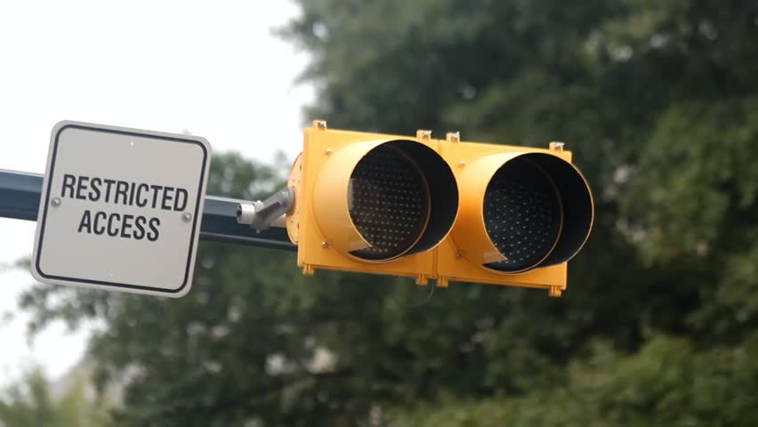 One Ambler Light Flashing Outside With A Restricted Access Sign