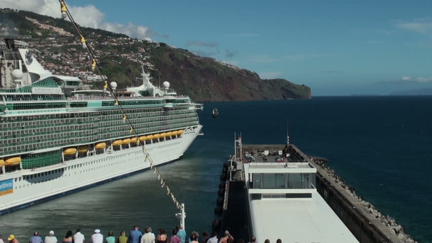 FUNCHAL, PORTUGAL - CIRCA MAY 2012: Time lapse of imposing ship cruise leaving Funchal harbor, Madeira, Portugal circa May 2012. Reverse zoom starting from a Santa Maria replica.