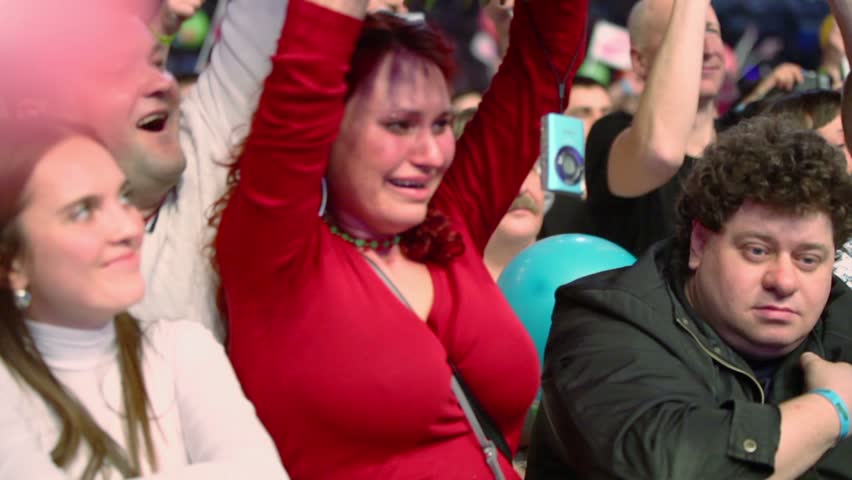 MOSCOW - DEC 17: Woman cries in rapture among people at concert of Legend RetroFM in Sports complex Olimpiyskiy, on Dec 17, 2011 in Moscow, Russia