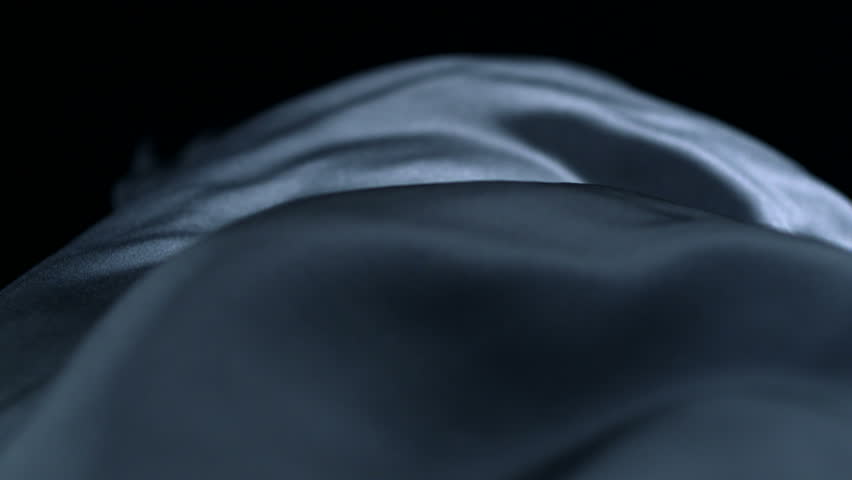 Grey silk fabric blowing in the wind shooting with high speed camera.