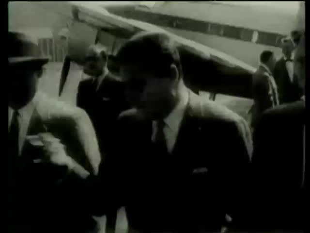 Mike Todd walks across tarmac in the airport before his last deadly flight on his private airplane "Lucky Liz" Spain circa 1958-MGM PICTURES, UNIVERSAL-INTERNATIONAL NEWSREEL, USA, filmed in 1958
