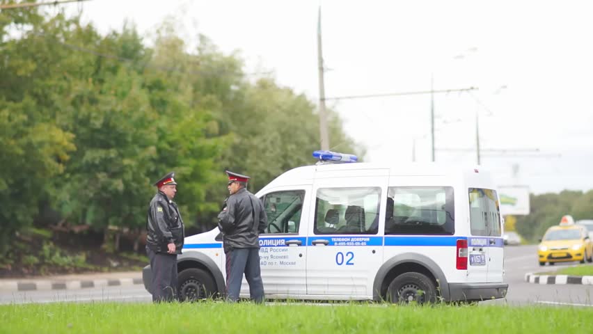MOSCOW - September 07: Road police officers on duty near police car on crossroad on September 07 , 2012 in Moscow,  Russia.