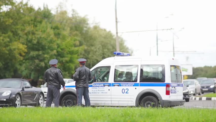 MOSCOW - September 07: Road police officers on duty near police car on crossroad on September 07 , 2012 in Moscow,  Russia.