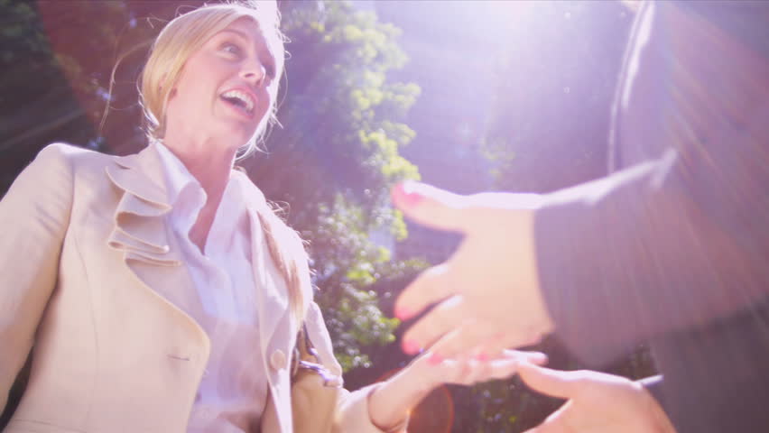 Business females being tactile in describing their success Shot on Red Epic