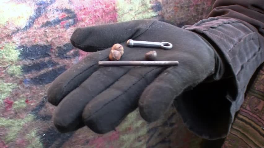 CAIRO, EGYPT â CIRCA DEC 2011: A hand shows the iron bullet of the firearms used by the police circa December 2011 in Tahrir Square, Cairo, Egypt.