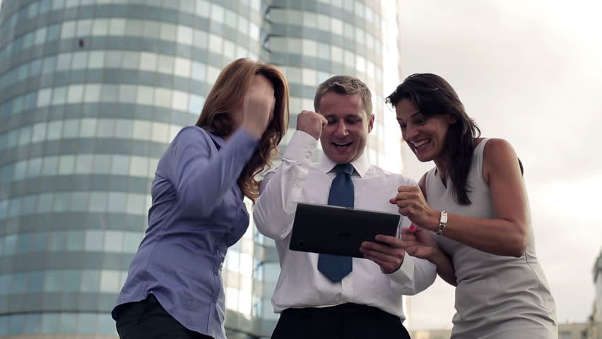 Business success - happy executives with tablet computer
