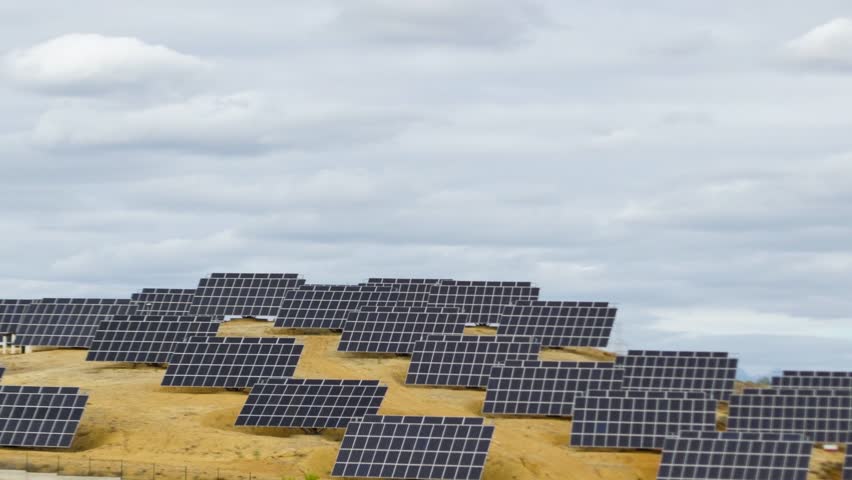 Time lapse sky over photovoltaic solar panels producing clean sustainable energy.