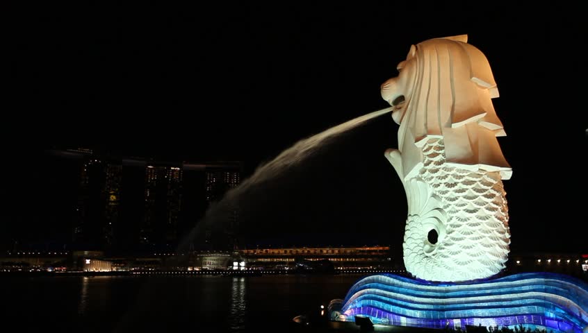 SINGAPORE - OCT 12: The Merlion at night on October 12, 2012. The Merlion is a mythical creature with the head of a lion and the body of a fish, used as a mascot of Singapore.