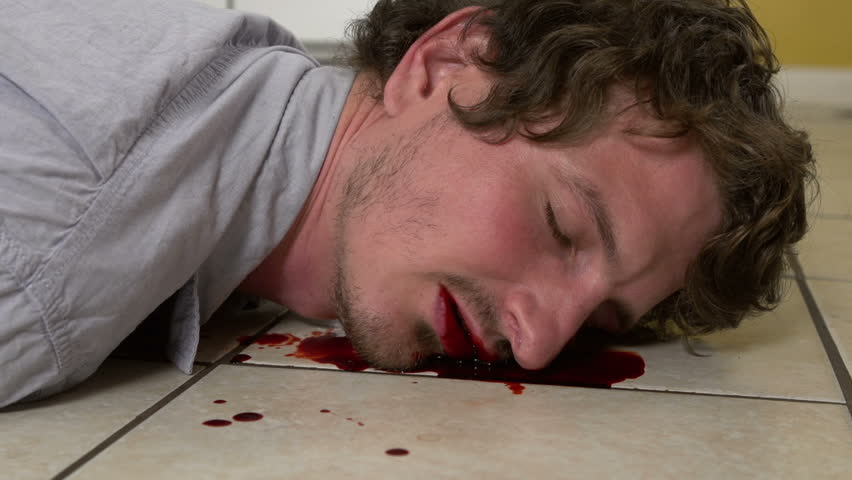 Man with bloody face on kitchen tile