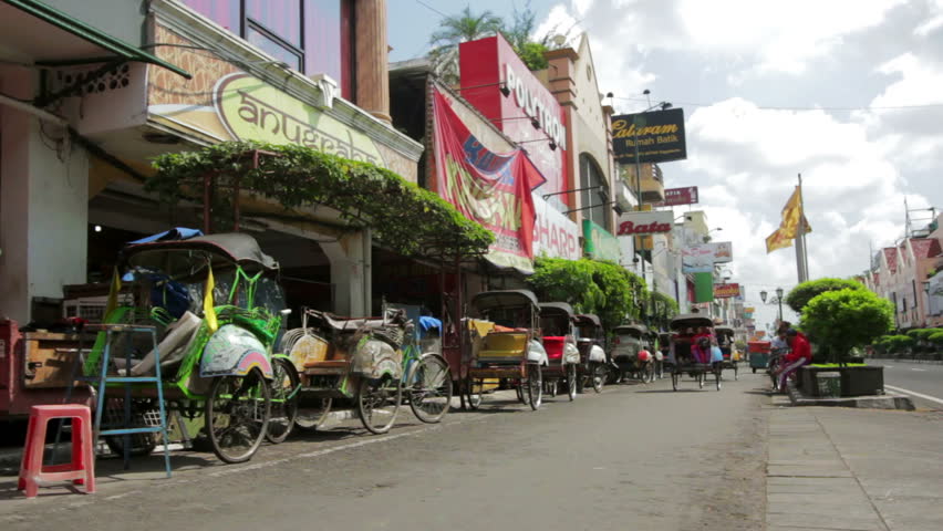 JOGJAKARTA - MAY 2012: transportation footage of pedal rickshaws