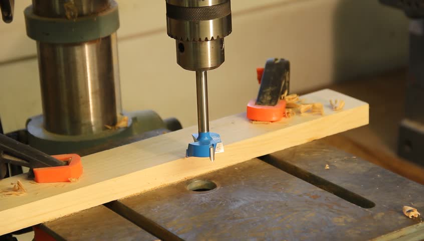 drill press operator drilling holes with a flush mount drill bit