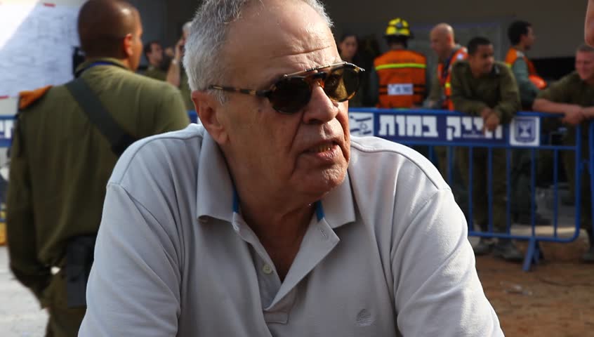 HOLON, ISRAEL - OCTOBER 21: Roni Daniel - military and security correspondent for Israeli Channel 2 talks to fireman during earthquake simulation drill, 2012