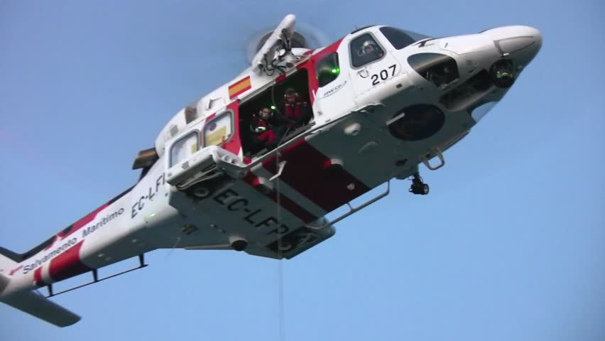ALICANTE COAST, SPAIN - OCTOBER 24: The helicopter of the Spanish  Maritime Rescue Team and his rescuers, take and wounded from a Spanish Navy boat, on october 24, 2012 in Alicante coast.