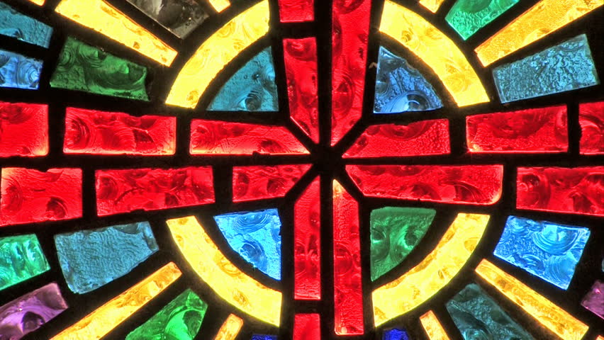 A small Christian church inside view of benches and beautiful stained glass window. Zoom out from window.