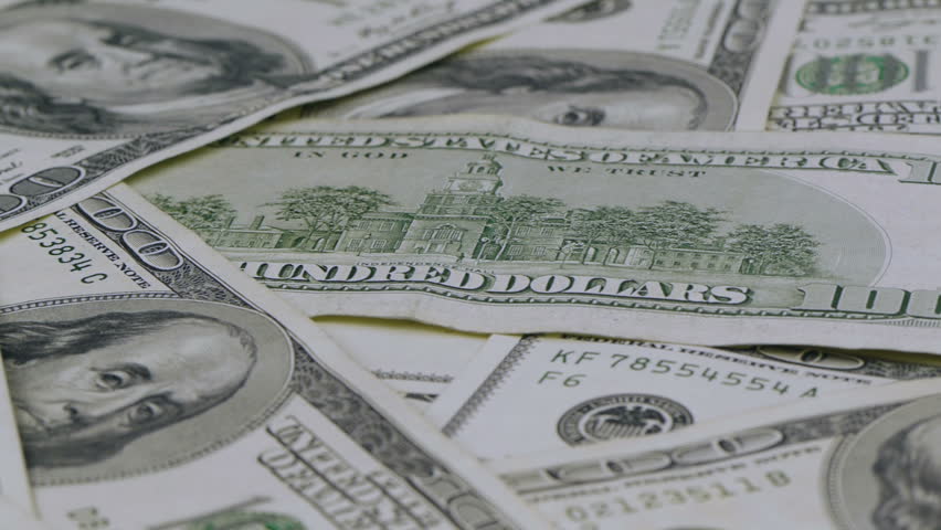 Hundred dollar bills panning macro with motorized dolly.