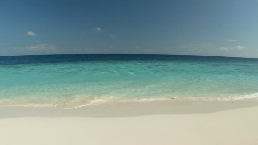 incoming gentle surf on a pristine beach. high definition video