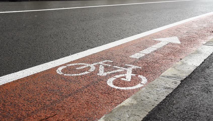 Red path with sign for bicyclists.