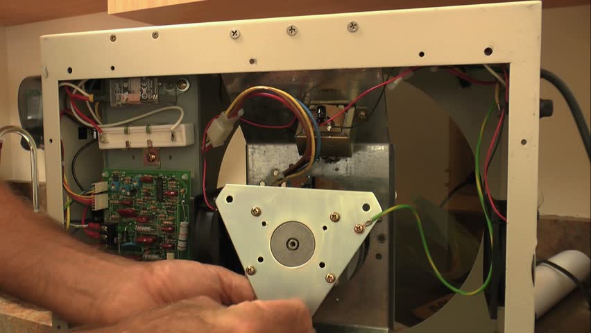 Biomedical service technician installs new motor assembly on centrifuge. 1080p