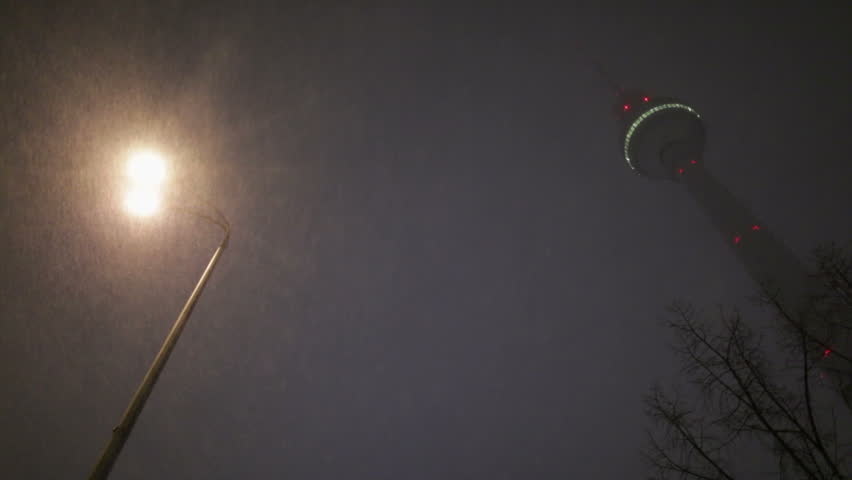 Berlin City Winter Night with strong Snowfall in front of TV Tower in 1080p FullHD, famous landmark in Berlin, Germany