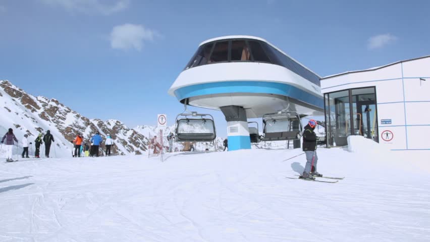 SOLDEN - FEBRUARY 12: People ride ski near cableway station in February 12, 2012 in Solden, Austria. Solden is located in center of Otstal valley where there are 250 peaks over 3000 meters