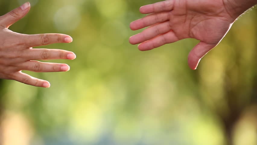 Detail of two lovers joining hands