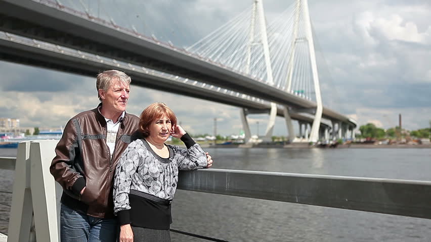 Mature couple admiring view of the river Neva. St. Petersburg, Obukhovsky Suspension Bridge, in Russia