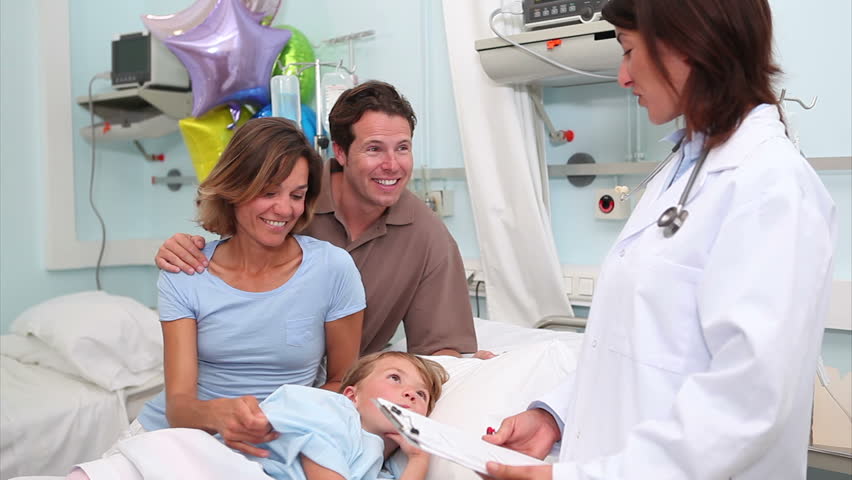 Smiling parents next to a doctor in hospital ward