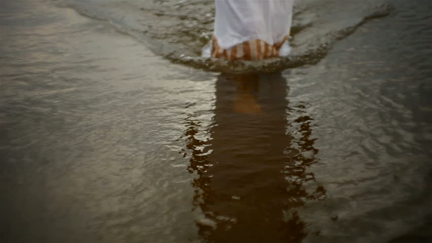 sunset. girl walking along the beach