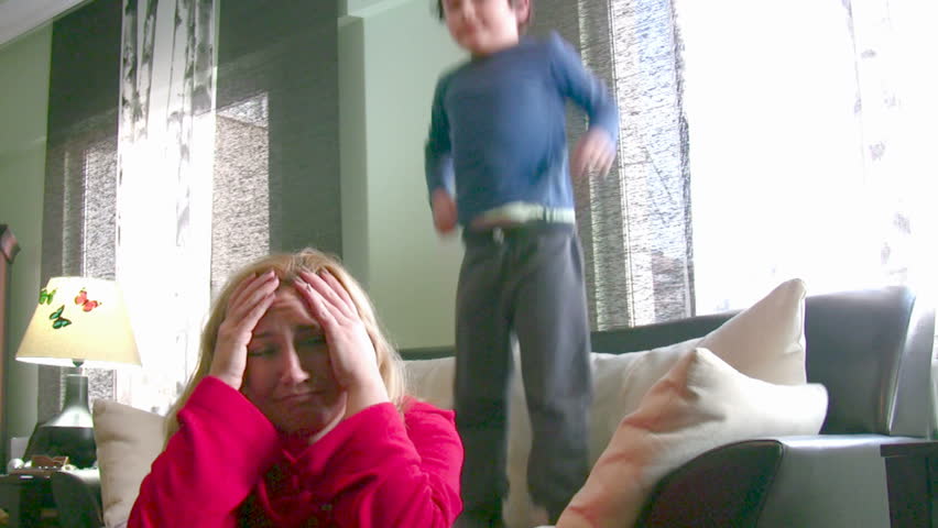 Noisy energetic little boy and tired mom