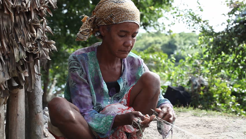 MADAGASCAR - CIRCAJULY 2012. Malagasy villager repairing fishing net. Funding shortfalls jeopardize World Food Programme's relief supplies deployed to cyclone-vulnerable areas in Madagascar.