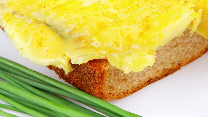 savory: fish fillet served over white plate with tomatoes,olives and bread