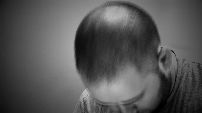 Man shaking his head and slowly going insane with effects added 

