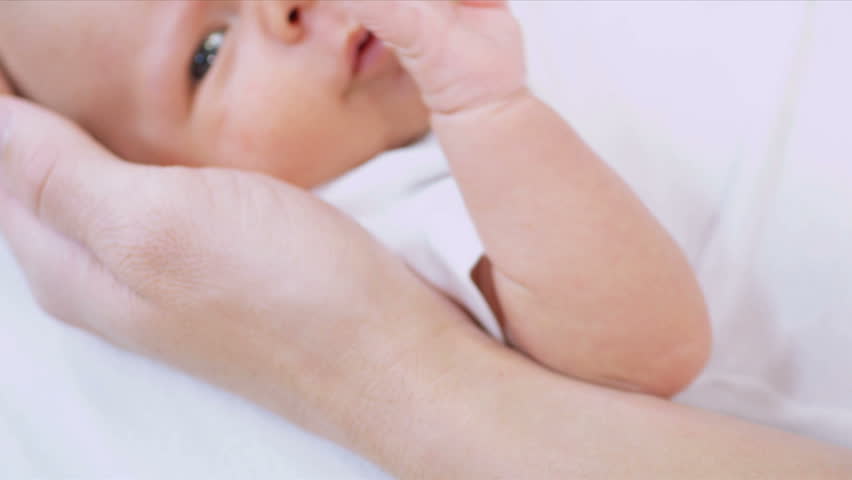 Close Up Parents Cradling Newborn baby